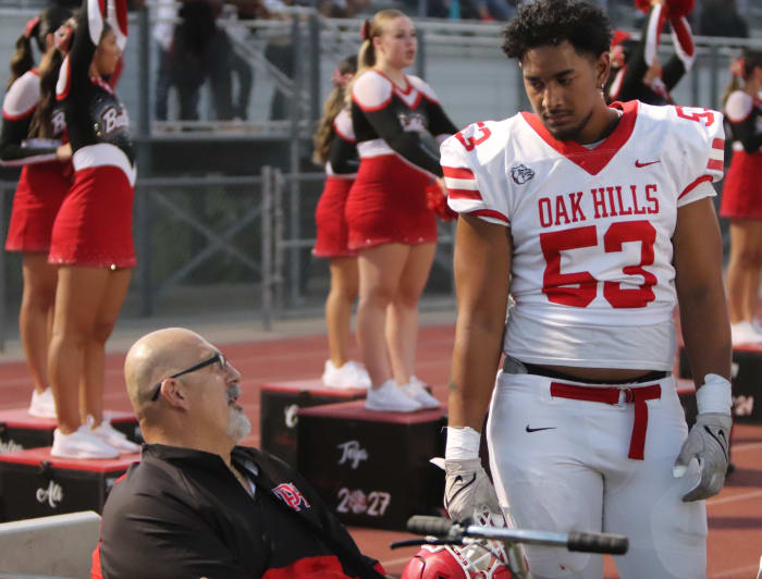 Oak Hills offensive line coach Nick Monica chatting it up with Paki Finau (53).
